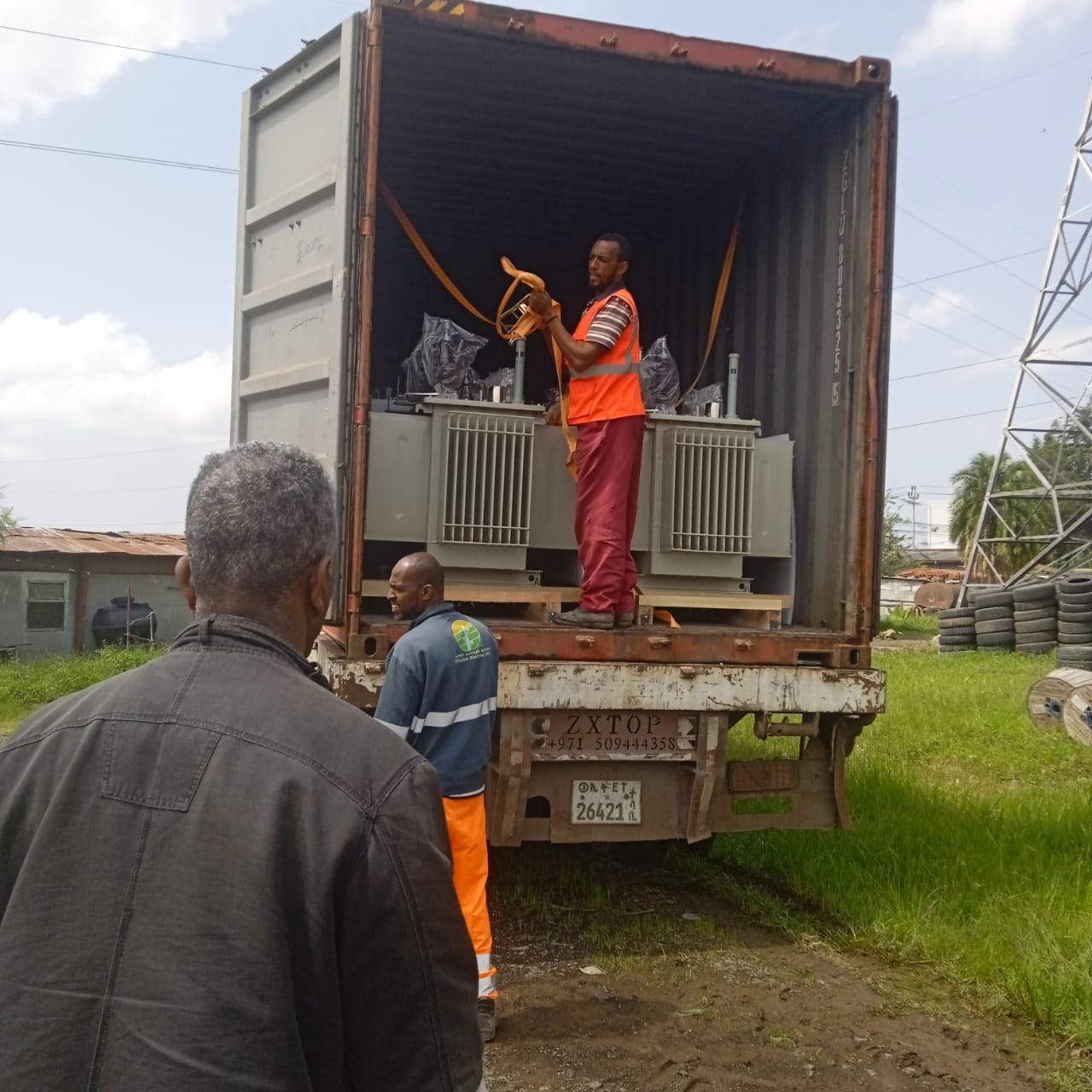 Workers unloading a 40HQ container of transformer components in Ethiopia